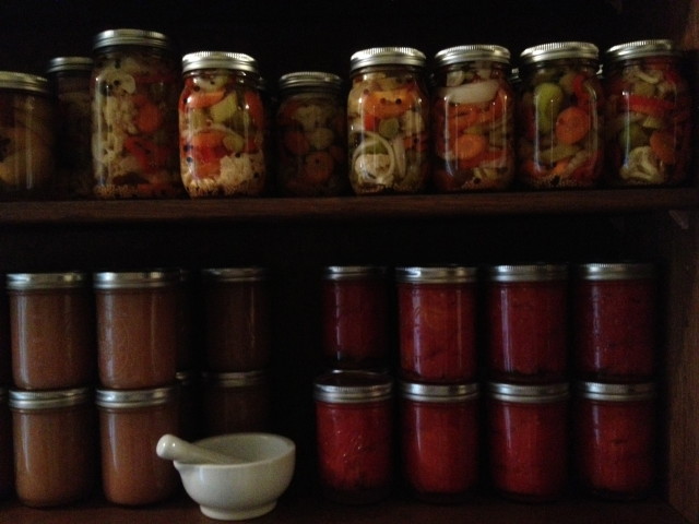 Top shelf: giardiniera (pickled Italian veggies). Bottom shelf: applesauce, tomatoes.