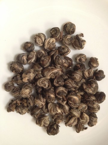 Jasmine tea leaves rolled into tight little pearls that unfurl in hot water.
